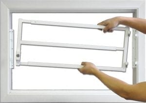 man removes window bars from window